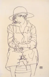 Ragazza seduta con cappello